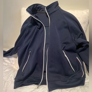 Nike athletic jacket with white zipper and underarm/rib piping detail. Pockets!
